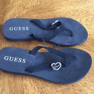 NWT Guess black flip flops with heart decor